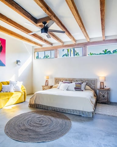 Casa Tocayo master suite with exposed beam ceiling